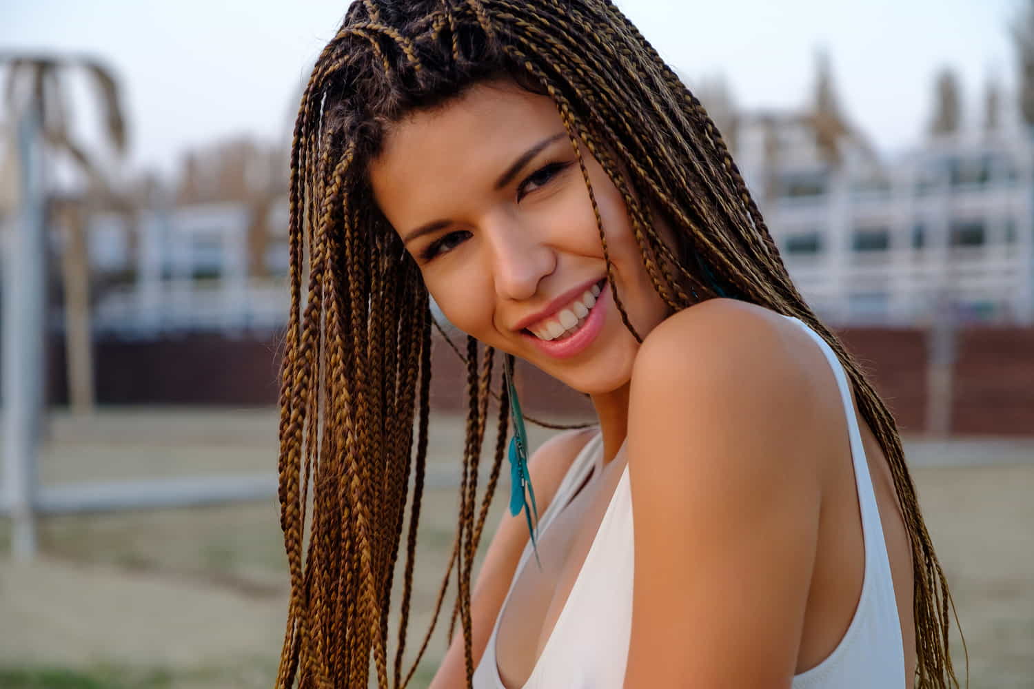 A woman showcasing her micro braided hairstyle.