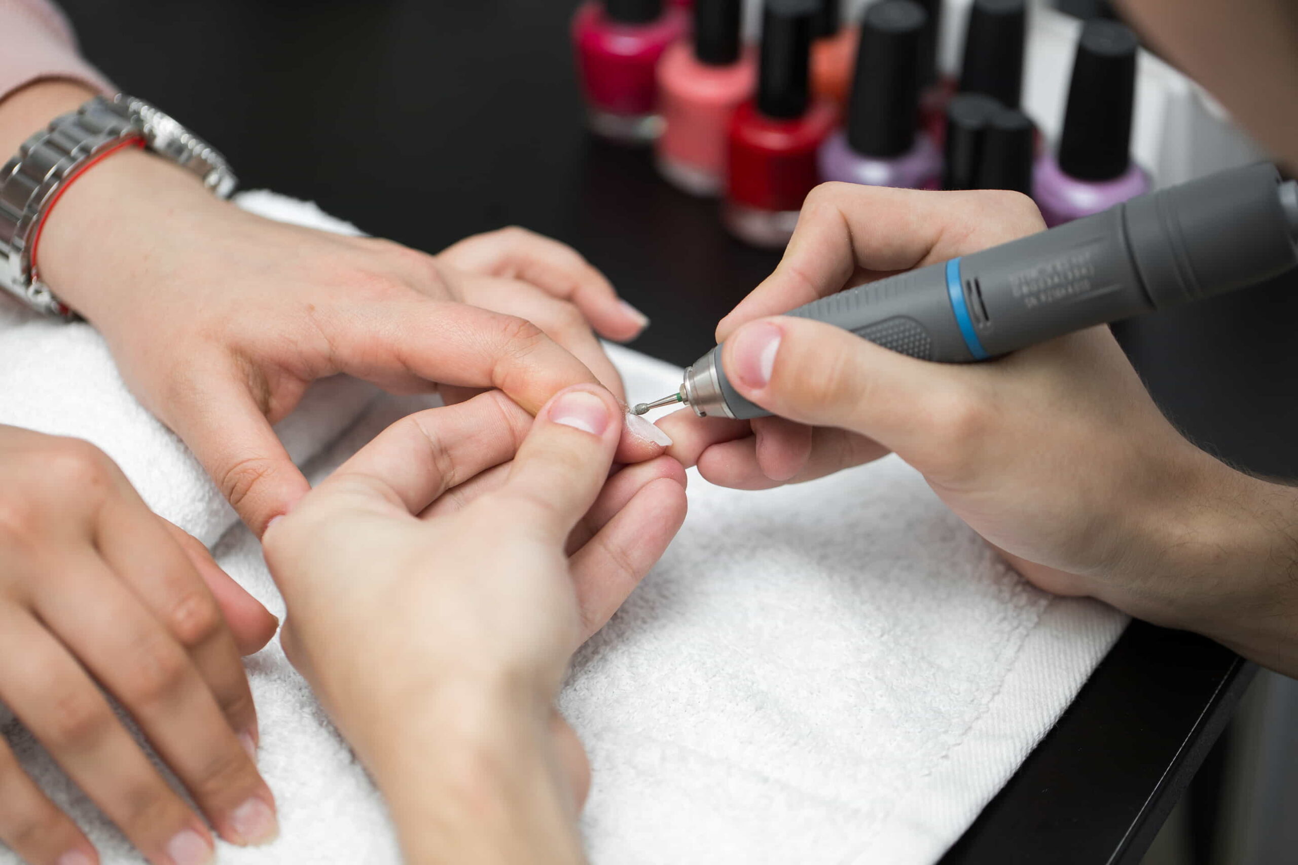 A nail technician meticulously prepping nails, ensuring a clean and smooth surface for nail art