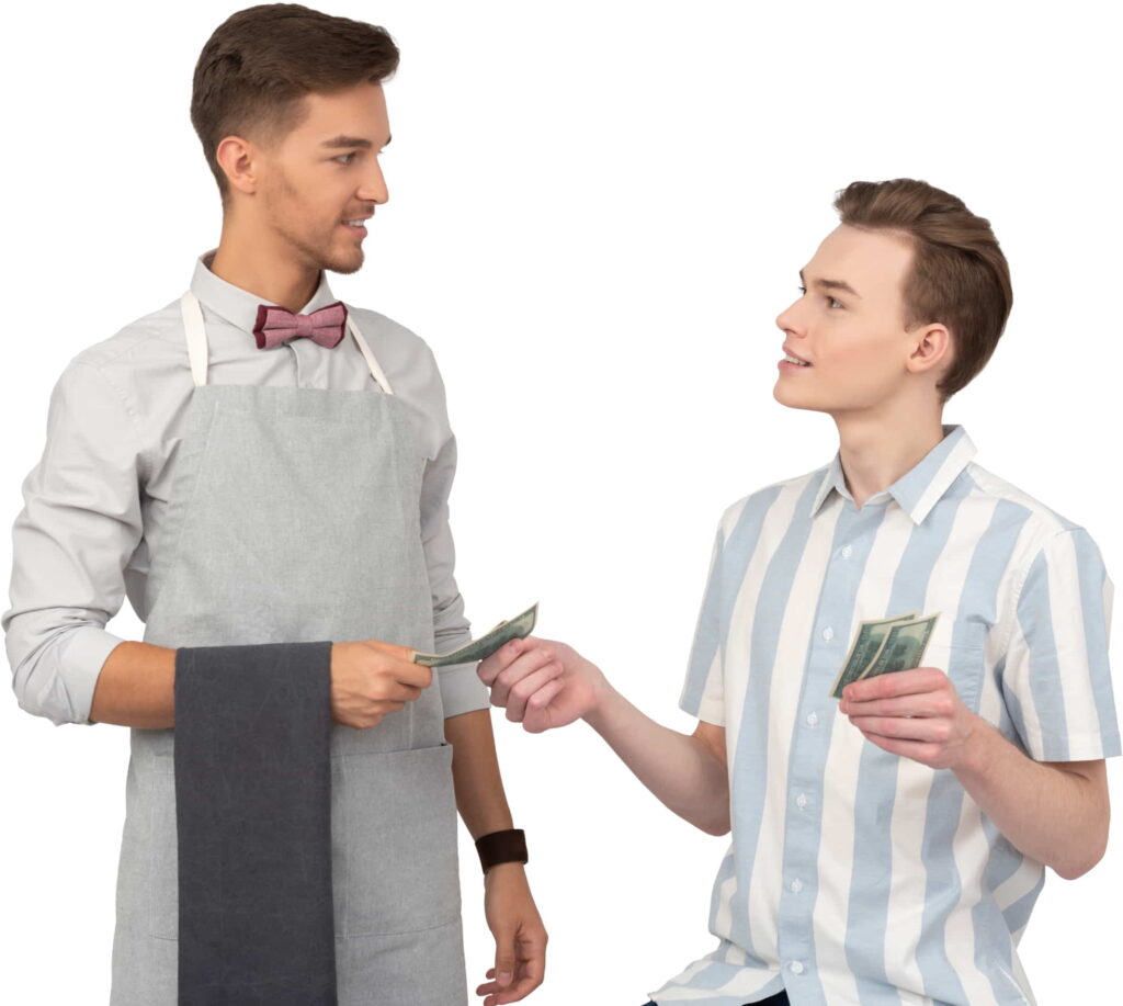 A satisfied customer handing a tip to his barber after a haircut